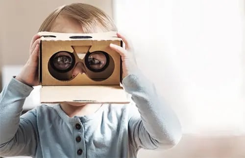 Baby playing with cardboard binoculars