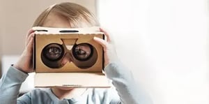 baby holding cardboard binoculars