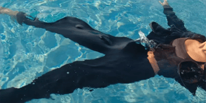 Person in pool with clothes on