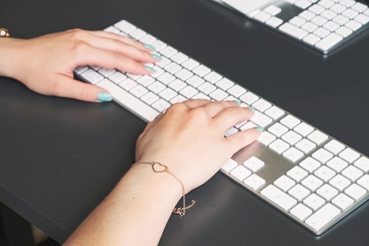 hands typing on keyboard