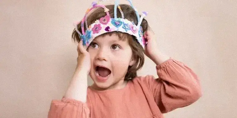 little girl holding a handmade crown little girl holding a handmade crown