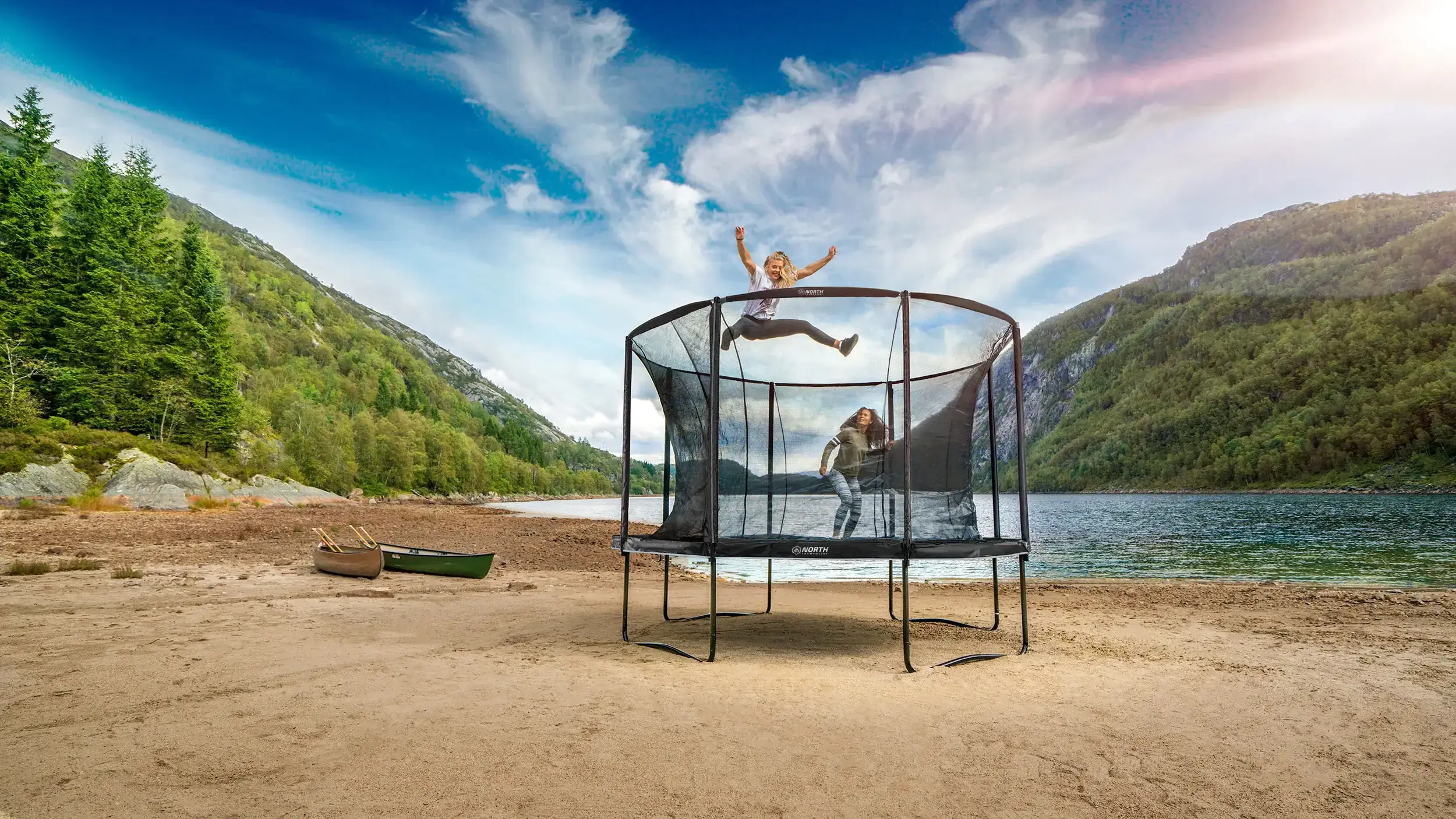 Kids jumping in a trampoline on a beach