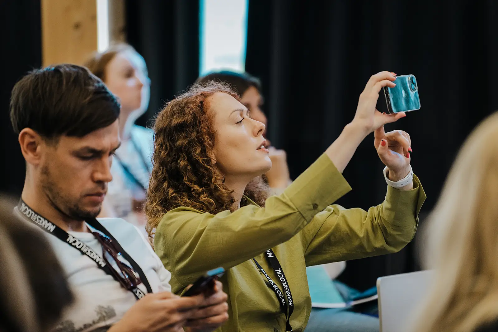 audience at Succeed Abroad taking a picture of e-commerce leader on stage